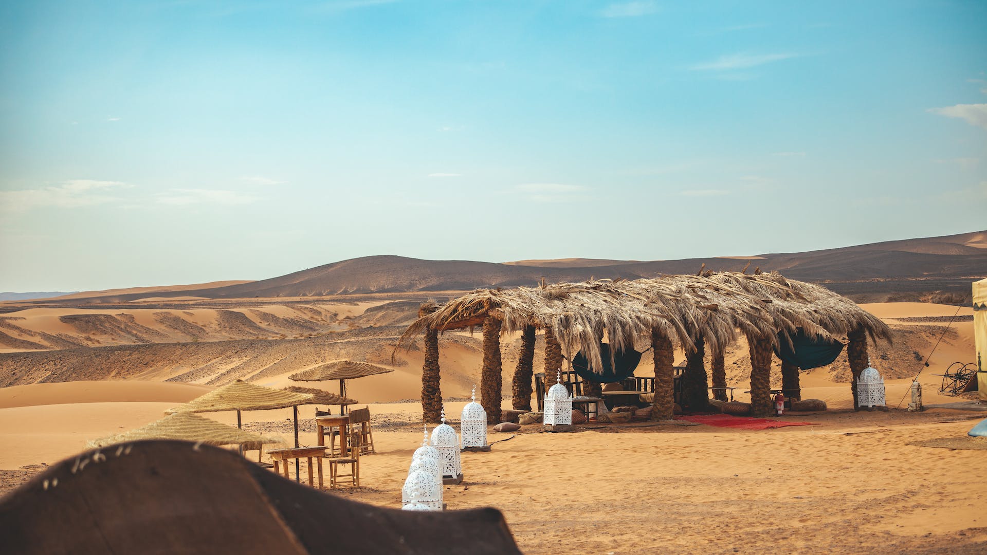 Image showcasing the luxurious accommodations of Camp Lux in Merzouga Desert, featuring well-appointed tents amidst the desert landscape, providing comfort and scenic views of the dunes