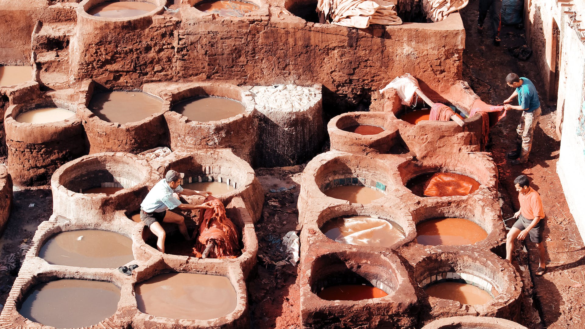 Image of Dar Al-Dabbagh in Fez, an ancient tannery renowned for Authentic Moroccan Leather. The historic establishment, dating back to the 11th century, showcases traditional leather tanning methods and craftsmanship, preserving Fez's cultural heritage